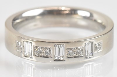 Lot 1239 - An 18ct white gold diamond wedding band, set...