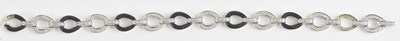 Lot 1342 - An 18ct white gold diamond and black onyx open...