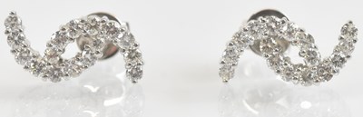 Lot 1239 - A pair of 18ct white gold earrings, each set...