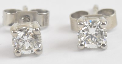 Lot 1399 - A pair of 18ct white gold diamond ear studs,...