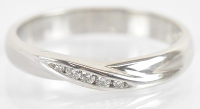 Lot 1248 - An 18ct white gold diamond set wedding band,...