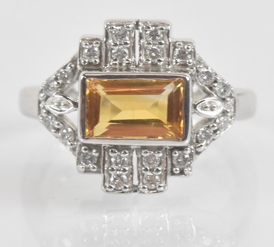 Lot 1265 - An 18ct white gold topaz and diamond lozenge...
