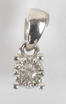 Lot 1477 - A 9ct white gold diamond pendant, the round...