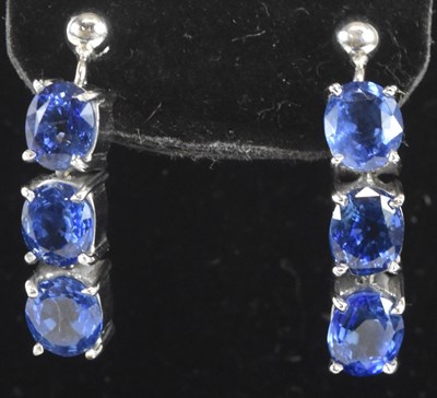 Lot 1393 - A pair of 9ct white gold three stone tanzanite...