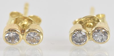 Lot 1396 - A pair of 18ct yellow gold diamond ear studs,...