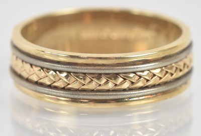 Lot 1320 - A 9ct yellow gold and white gold wedding band,...