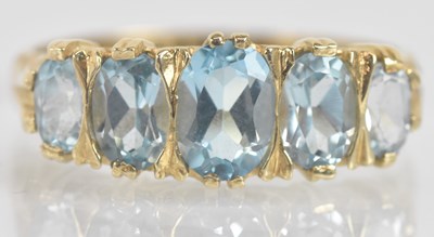 Lot 1321 - A 9ct yellow gold five stone graduated blue...