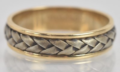 Lot 1322 - A 9ct yellow and white gold wedding band, with...