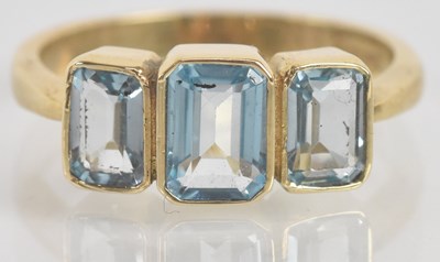 Lot 1319 - A 9ct yellow gold and topaz three stone...