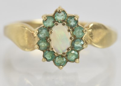 Lot 1315 - A 9ct yellow gold opal and emerald flower head...