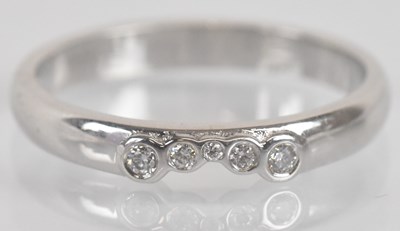 Lot 1292 - An 18ct white gold and five stone round...