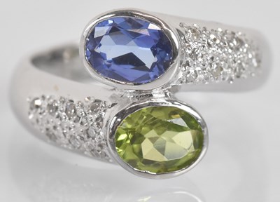 Lot 1240 - An 18ct white gold green peridot, tanzanite...