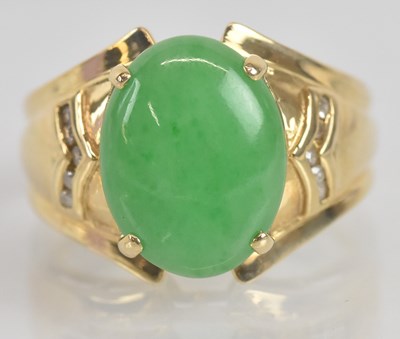 Lot 1255 - A 14ct yellow gold oval cabochon jade set ring...