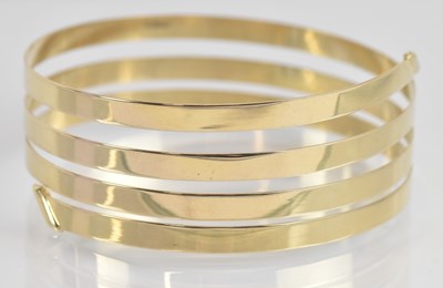 Lot 1345 - A 9ct yellow gold thin sprung bangle, approx...