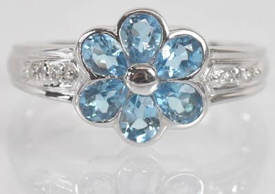 Lot 1284 - An 18ct white gold blue topaz and diamond set...