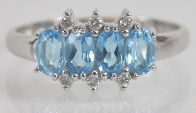 Lot 1290 - An 18ct white gold blue topaz and diamond set...