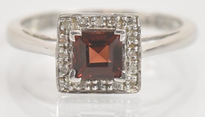 Lot 1325 - A 9ct white gold ruby and diamond ring in...