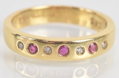Lot 1269 - An 18ct yellow gold diamond and ruby ring set...