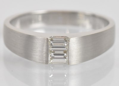 Lot 1275 - An 18ct white gold diamond set ring, with twin...
