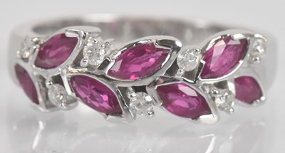 Lot 1263 - An 18ct white gold ruby and diamond leaf...