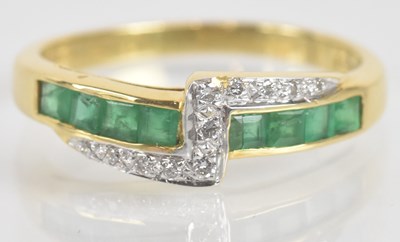 Lot 1281 - An 18ct yellow gold diamond and emerald ring,...