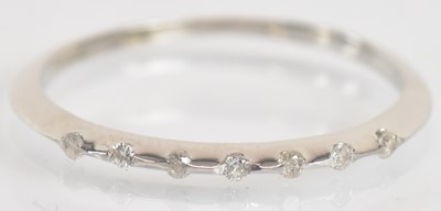 Lot 1312 - A thin 9ct white gold seven stone diamond set...
