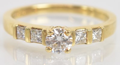 Lot 1254 - An 18ct yellow gold five stone diamond ring,...