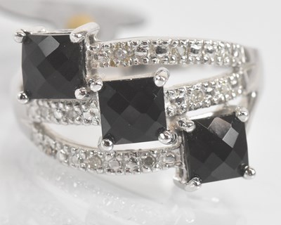 Lot 1327 - A 9ct white gold black onyx and diamond ring...