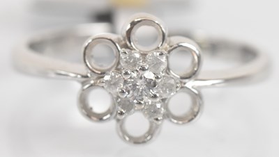 Lot 1314 - A 9ct white gold diamond flower head ring,...