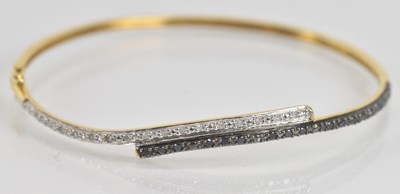 Lot 1346 - A 9ct yellow gold diamond and black diamond...