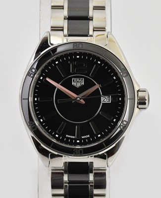 Lot 25 - TAG HEUER; a lady's stainless steel and black...