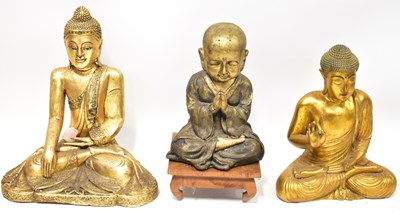 Lot 238 - Three gold-coloured Buddha figures, each...
