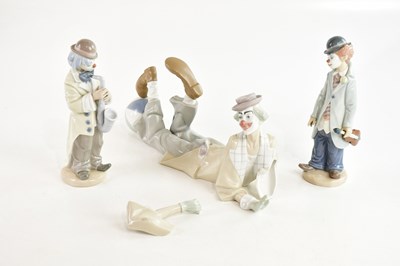Lot 1495 - LLADRÓ; three figures comprising clown playing...