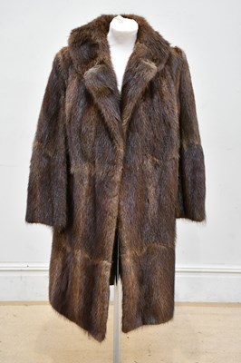 Lot 784 - A knee length light brown beaver fur coat with...