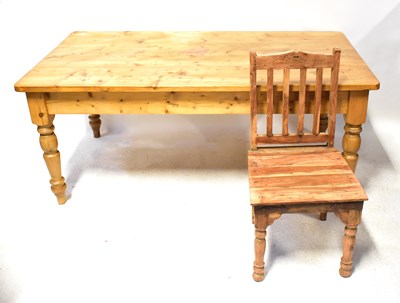 Lot 104 - A waxed pine dining table, on turned legs, 77...