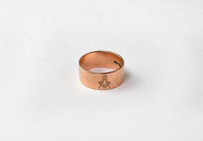 Lot 1077 - A 9ct rose gold wedding band with engraved...