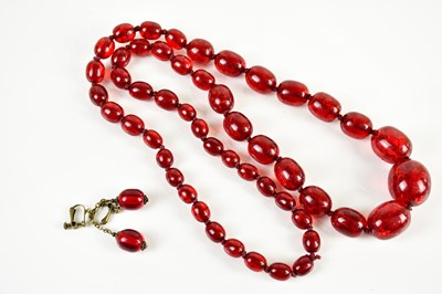 Lot 432 - A cherry amber coloured bead necklace, with...