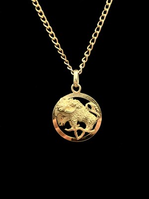 Lot 1192 - An 18ct yellow gold pierced circular Taurus...