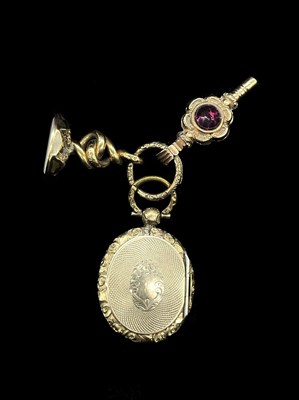 Lot 1185 - A Victorian yellow metal oval locket, centred...