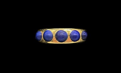 Lot 1189 - An 18ct yellow gold and lapis lazuli set ring,...