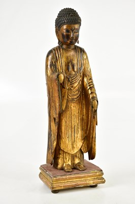 Lot 1358 - A carved gilt wood and lacquered figure of...