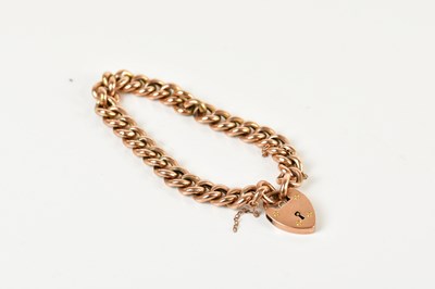 Lot 241 - A rose metal curb link bracelet with 9ct gold...