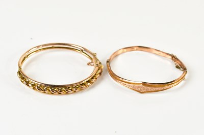 Lot 242 - A 9ct yellow gold hinged bangle, the front...