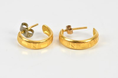 Lot 300 - A pair of yellow metal hoop earrings, with...
