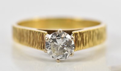 Lot 115 - An 18ct textured yellow gold diamond solitaire...
