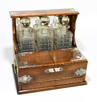 Lot 12 - A late Victorian oak three bottle...