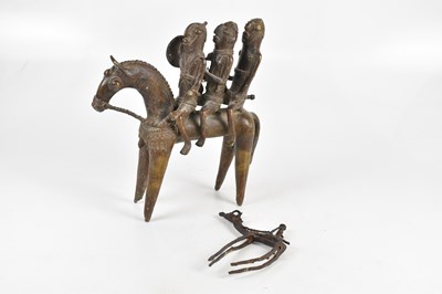 Lot 1321 - A Benin bronze group of three male figures on...