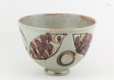 Lot 719 - A deep stoneware bowl covered in pale green...
