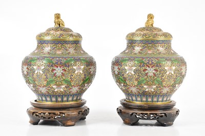 Lot 1339 - A pair of decorative cloisonné jars and covers...