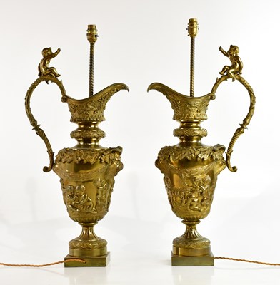 Lot 1291 - A pair of bronze table lamps representing...